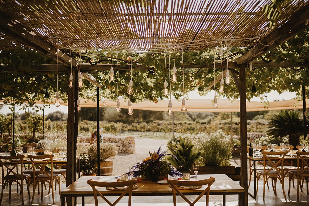 Top Sweetheart Table Purple Yellow Flowers Festoon Lights Binifadet Wedding Laura Mazzello Photography