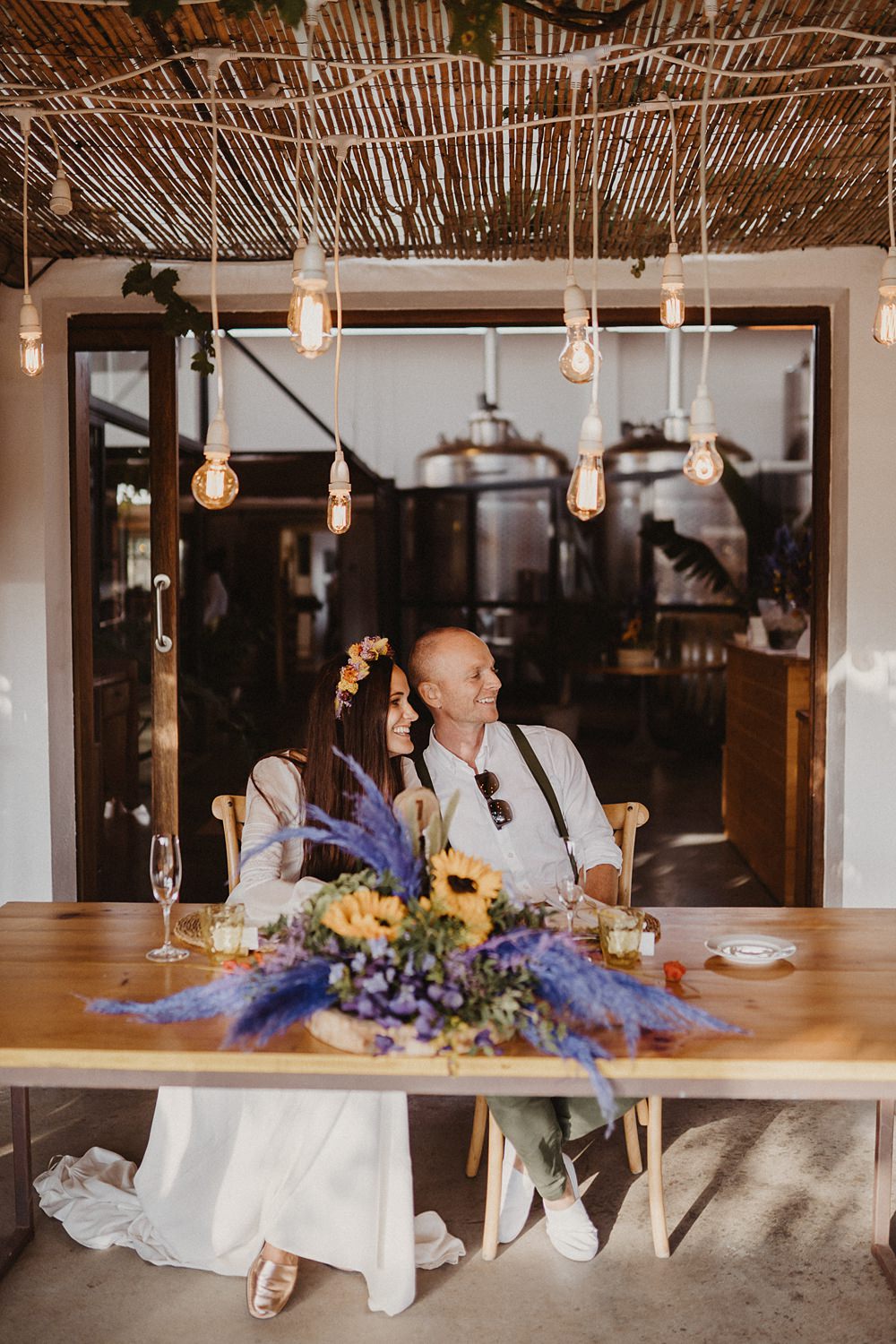 Top Sweetheart Table Purple Yellow Flowers Festoon Lights Binifadet Wedding Laura Mazzello Photography