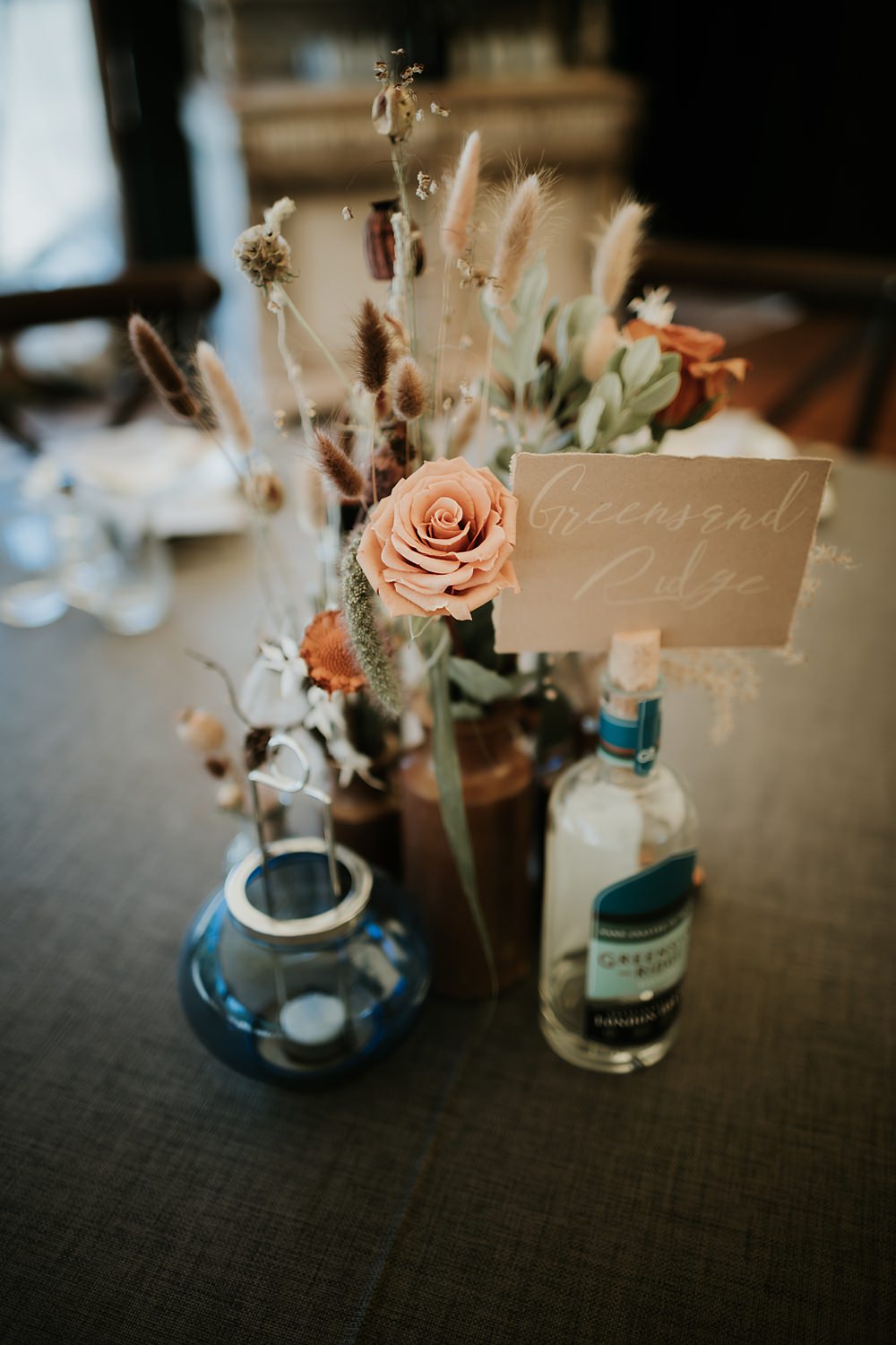 Centrepiece Flowers Bottles Dried Palms Kent Woodland Wedding Paul Fuller Photography