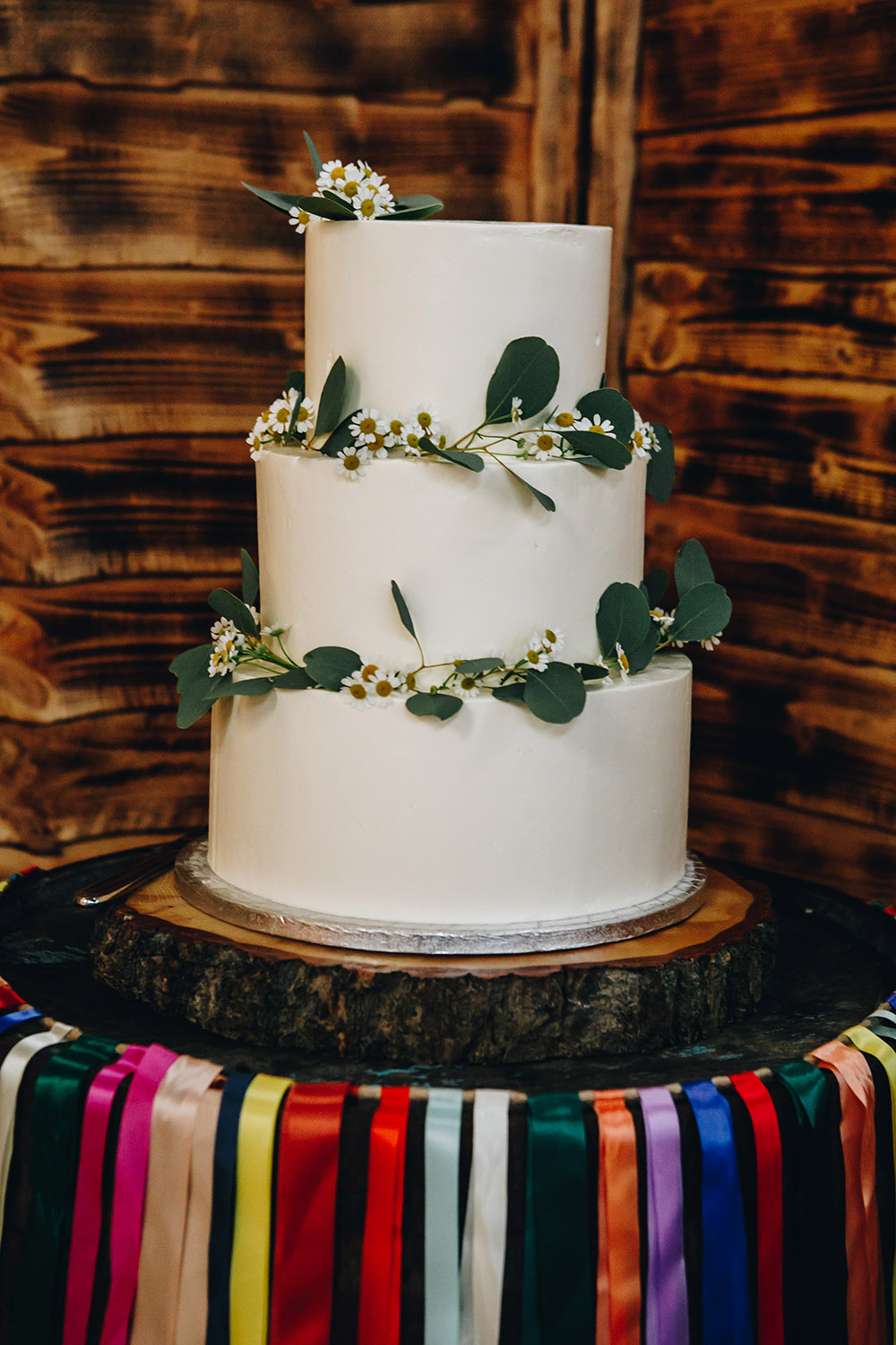 Iced Cake Greenery Rainbow Ribbon Barrell Stand Northumberland Barn Wedding Erika Tanith Photography