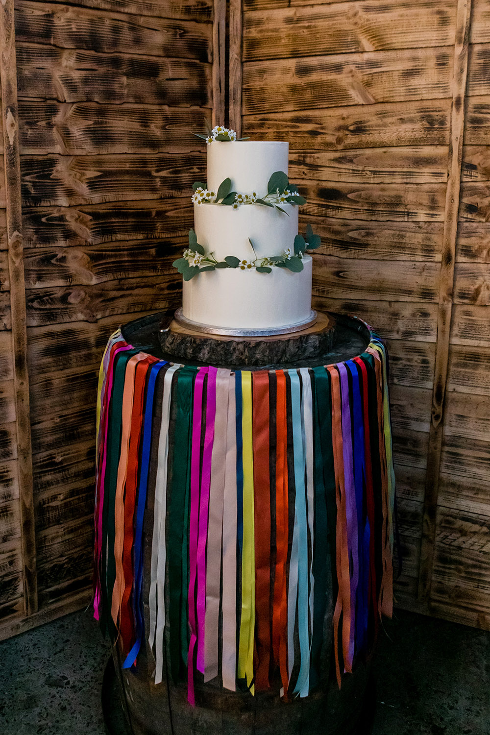 Iced Cake Greenery Rainbow Ribbon Barrell Stand Northumberland Barn Wedding Erika Tanith Photography