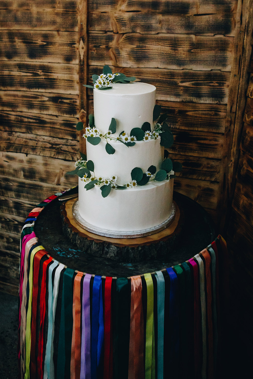 Iced Cake Greenery Rainbow Ribbon Barrell Stand Northumberland Barn Wedding Erika Tanith Photography