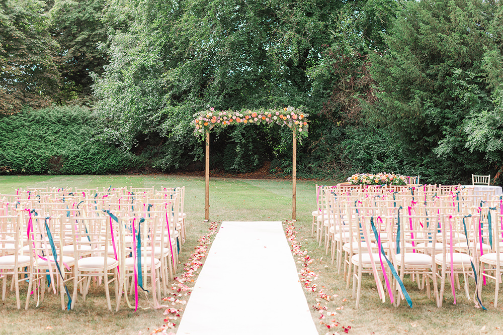 Holbrook Manor Wedding James & Kerrie Photography Flower Arch Rainbow Ribbons Chairs Ceremony Outdoor