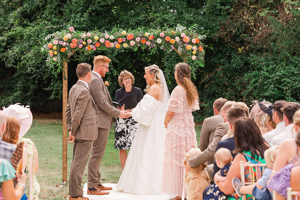 Flower Arch Rainbow Ribbons Chairs Ceremony Outdoor Holbrook Manor Wedding James & Kerrie Photography