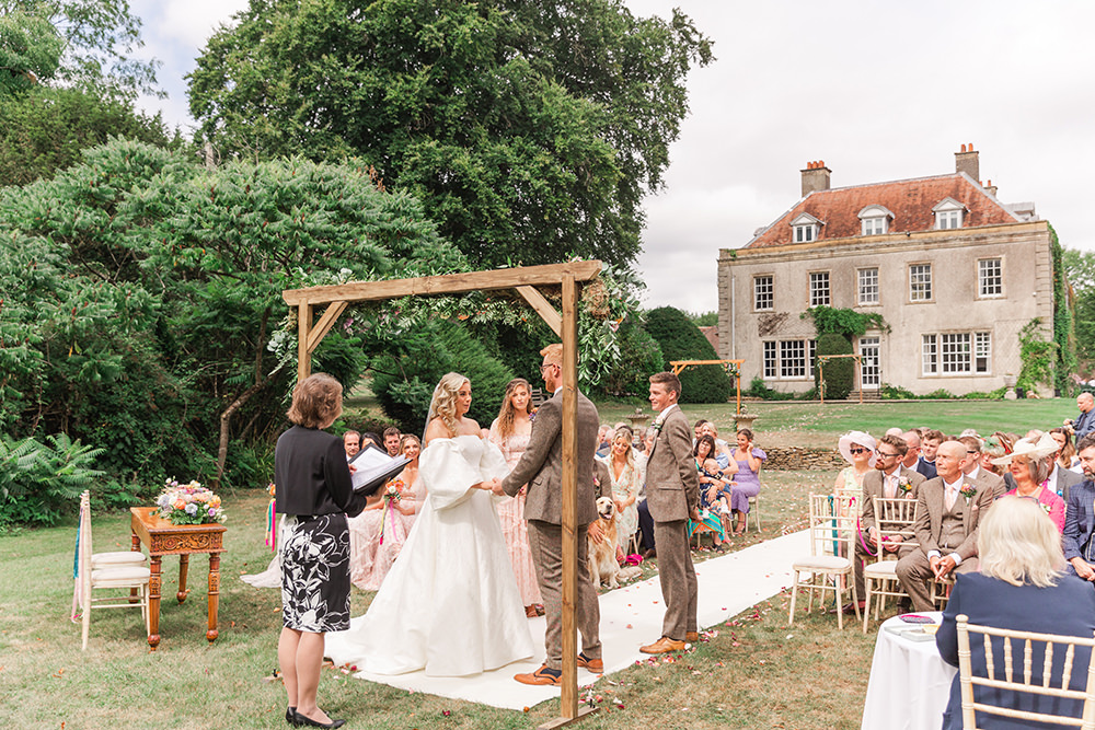 Flower Arch Rainbow Ribbons Chairs Ceremony Outdoor Holbrook Manor Wedding James & Kerrie Photography