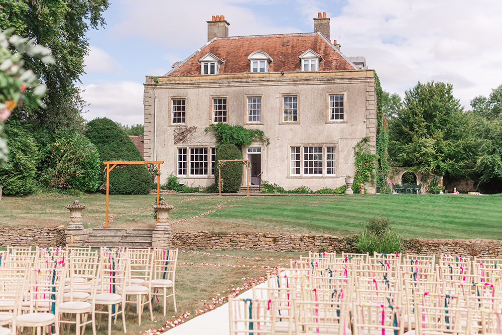 Flower Arch Rainbow Ribbons Chairs Ceremony Outdoor Holbrook Manor Wedding James & Kerrie Photography