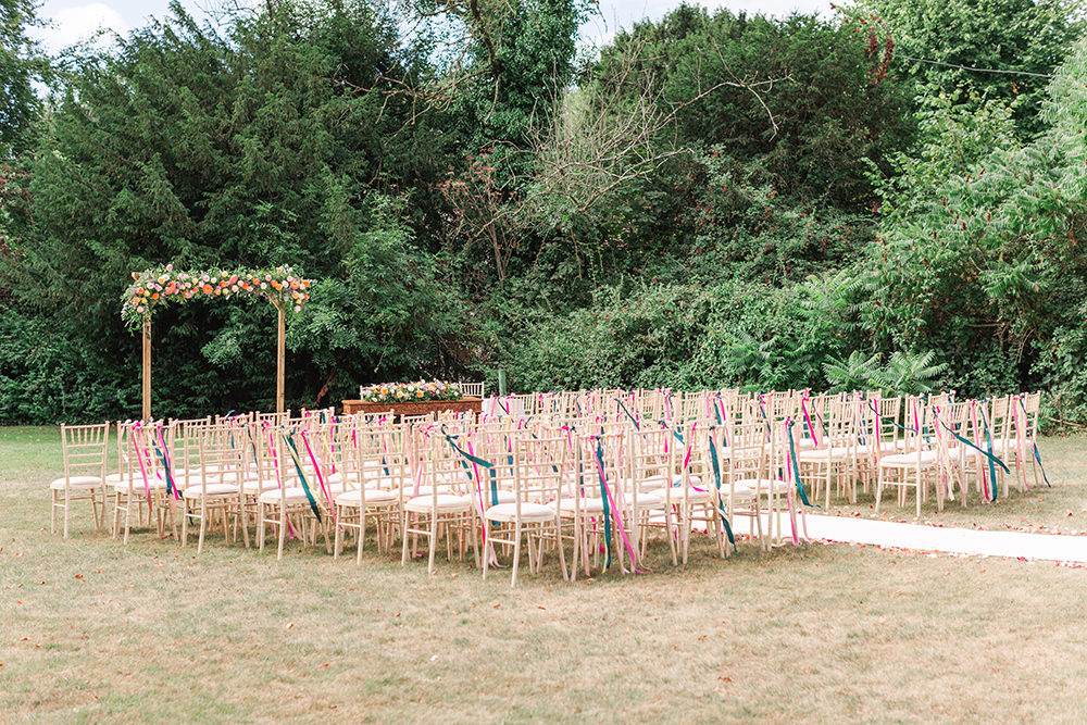 Flower Arch Rainbow Ribbons Chairs Ceremony Outdoor Holbrook Manor Wedding James & Kerrie Photography