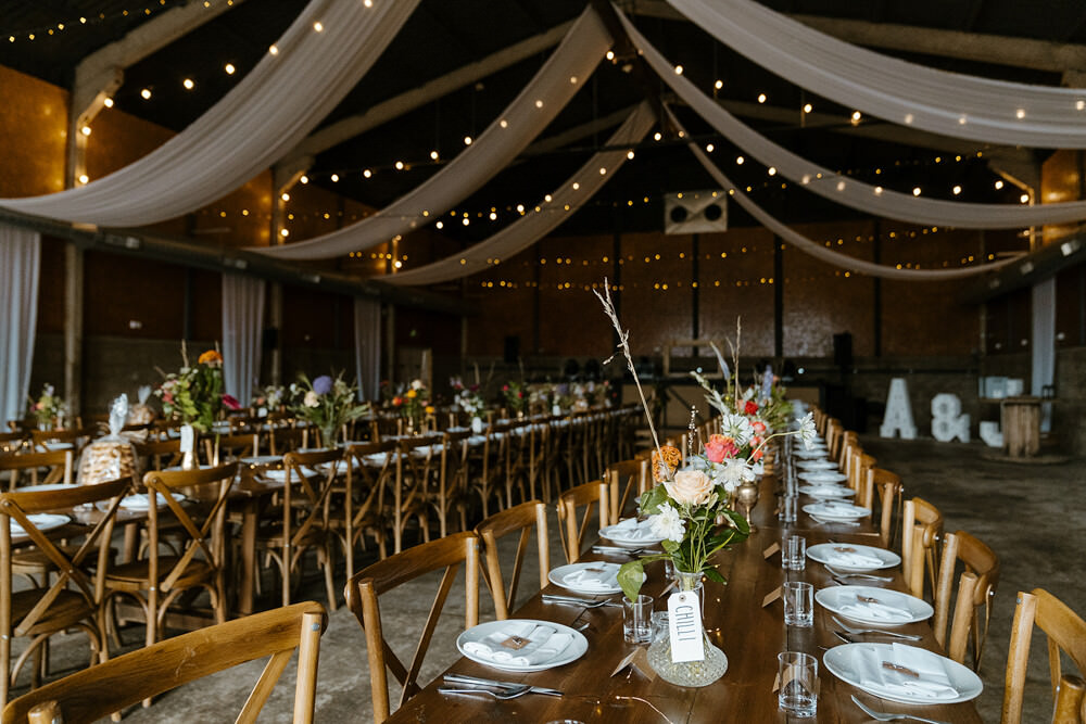 Long Wooden Tables Barn Decor Flowers Indian Lithuanian Wedding Ellie Gillard Photography