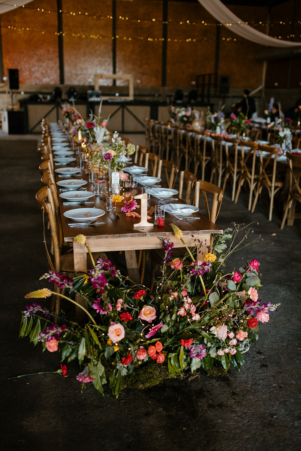 Long Wooden Tables Barn Decor Flowers Meadow Indian Lithuanian Wedding Ellie Gillard Photography