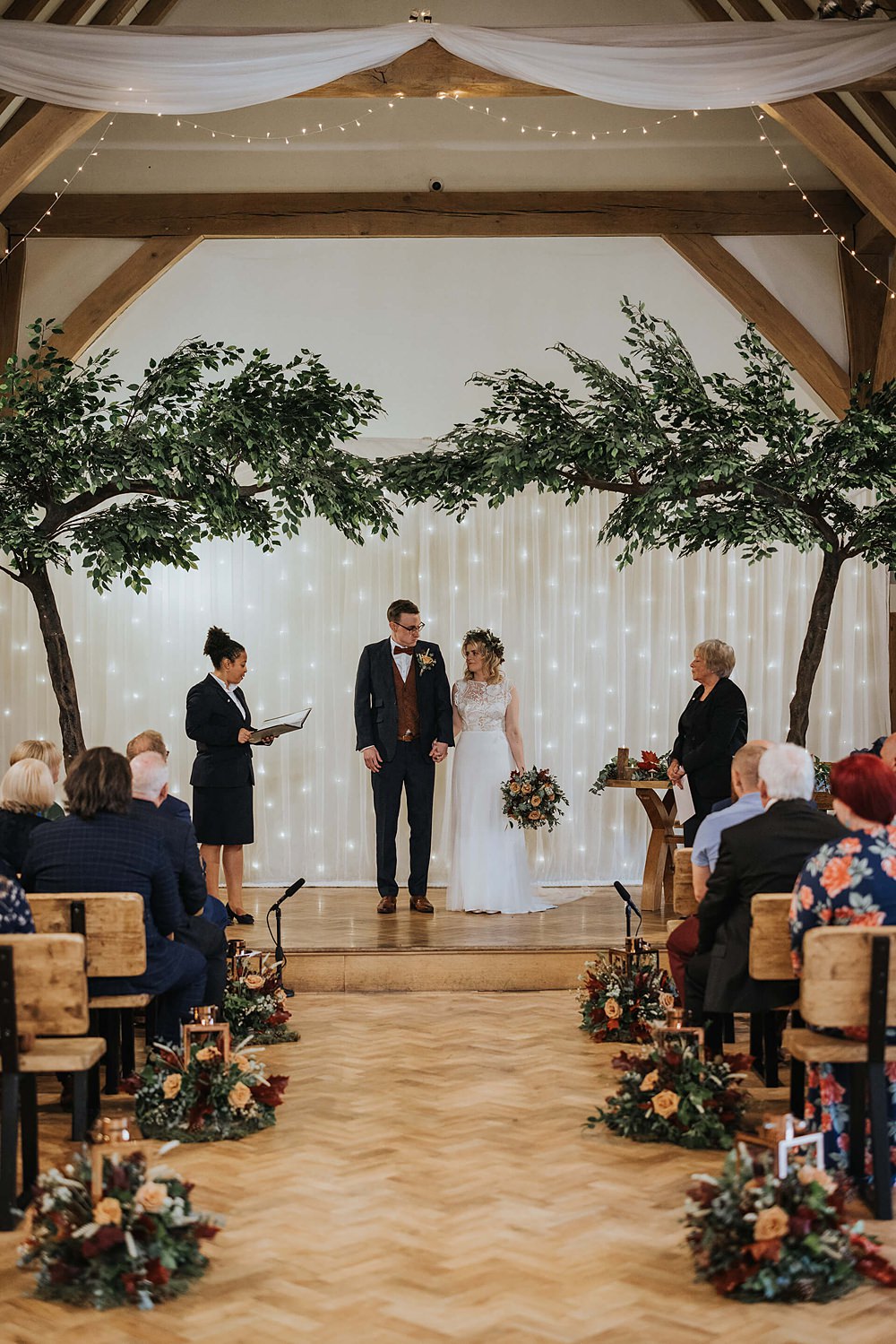Ceremony Aisle Flowers Trees Fairy Light Curtain Readings Old Kent Barn Wedding Olegs & Rita Photography