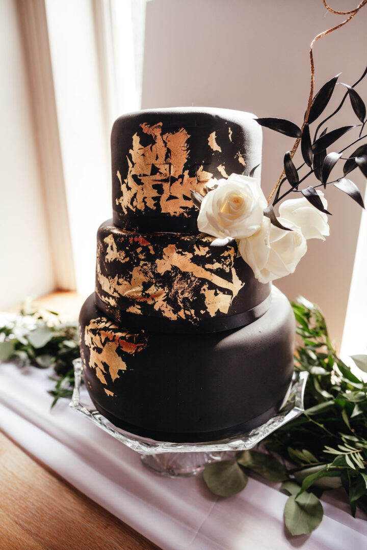 Black Gold Leaf White Flowers Wedding Cake Lase Photography