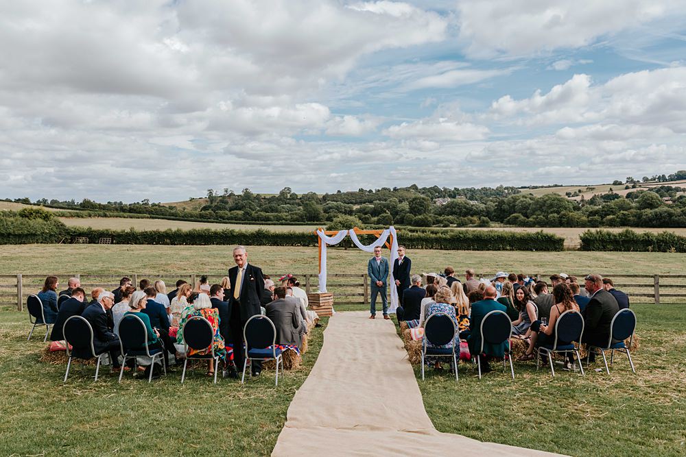 Outdoor Ceremony Wooden Arch Backdrop Yorkshire Village Hall Wedding Maddie Farris Photography