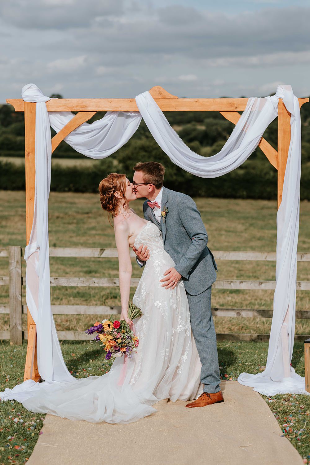 Outdoor Ceremony Wooden Arch Backdrop Yorkshire Village Hall Wedding Maddie Farris Photography