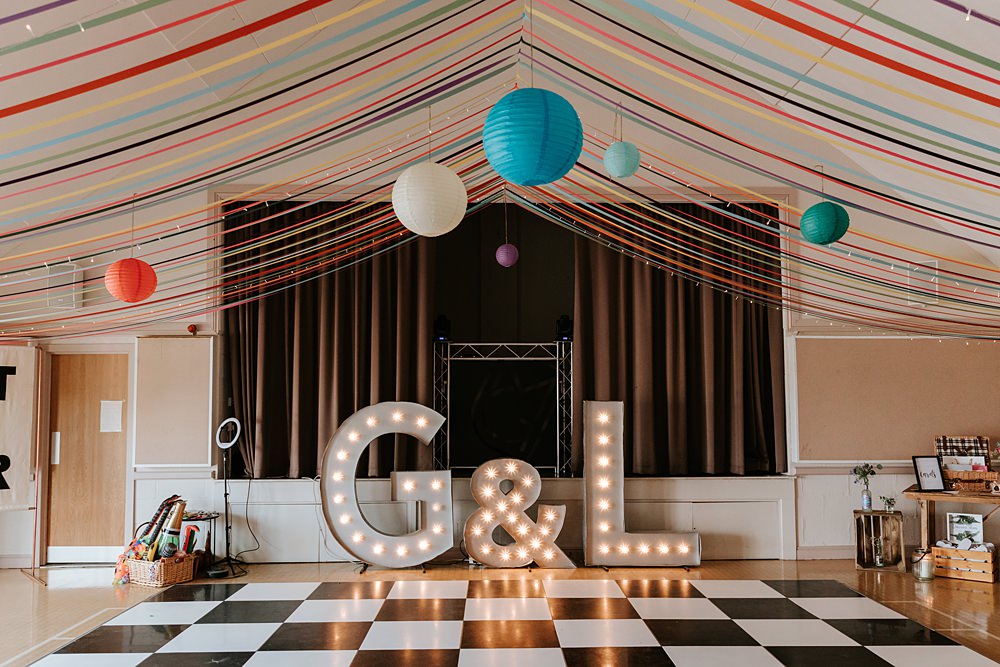 Streamers Lanterns Colourful Fairy Light Curtain Decor Letter Lights Yorkshire Village Hall Wedding Maddie Farris Photography