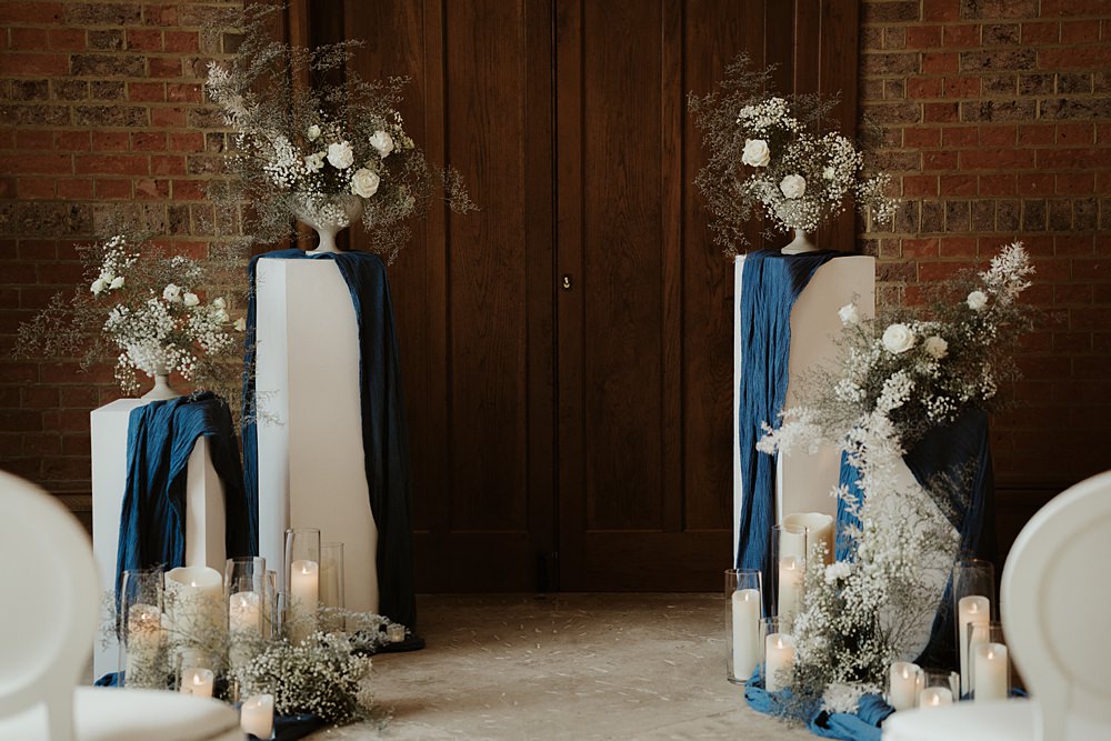 Ceremony Backdrop Pillars Flowers Candles Blue White Wedding Ideas Natalie Silvester Photography