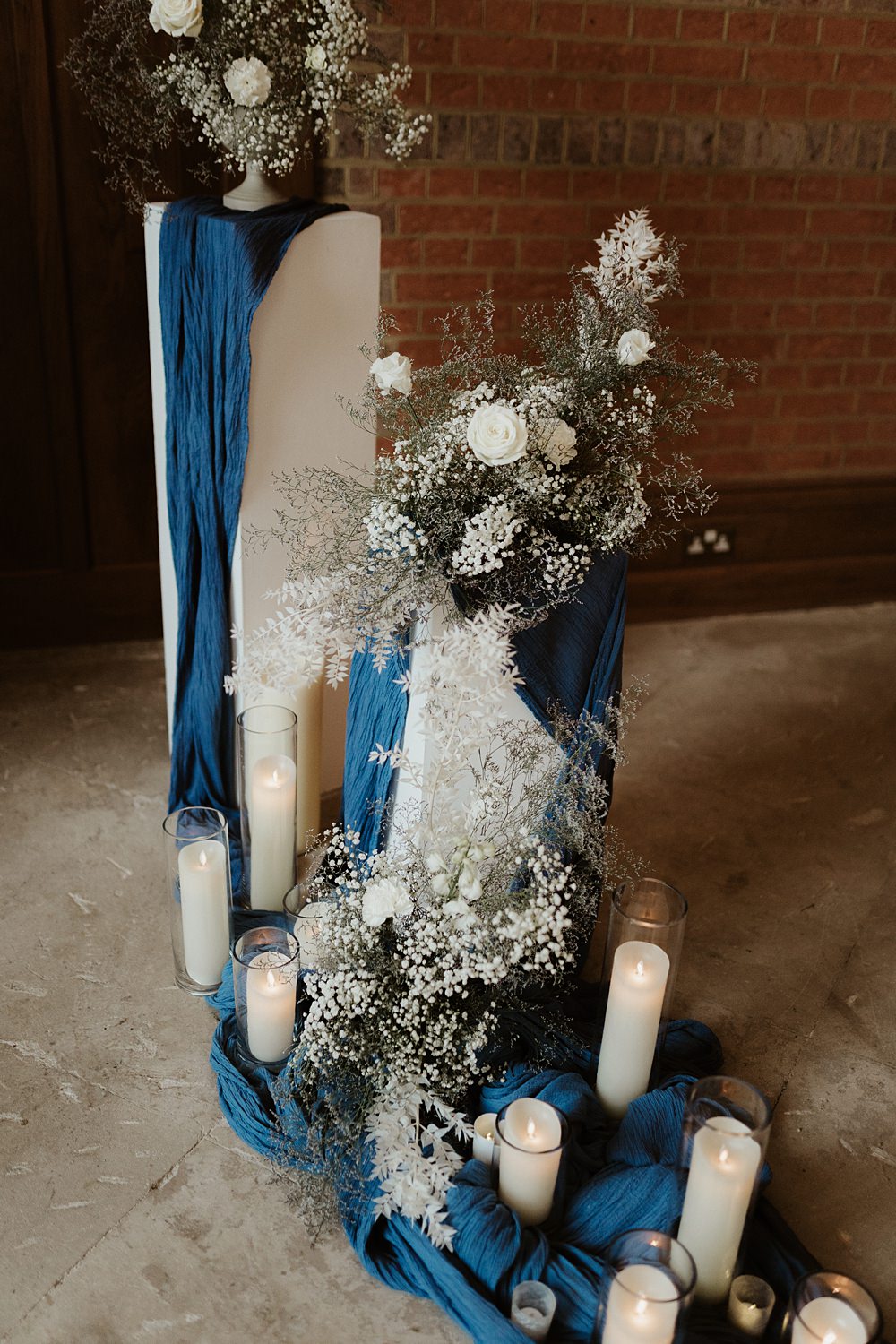 Ceremony Backdrop Pillars Flowers Candles Blue White Wedding Ideas Natalie Silvester Photography