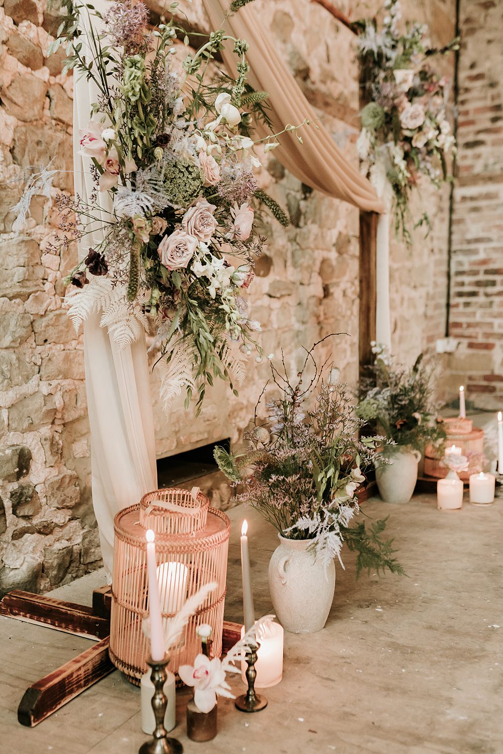 Backdrop Arch Flowers Drapes Candles Beige Barn Boho Wedding Gabrielas Photography and Film