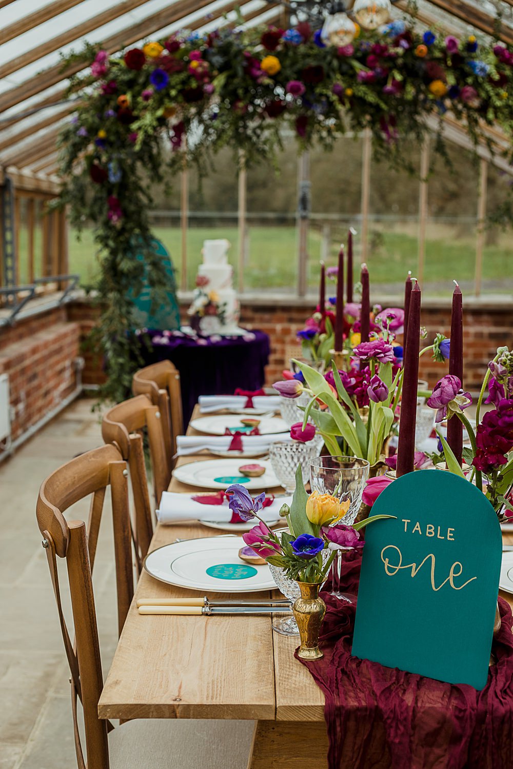Somersbury Barn Wedding Thorn and Found Flowers Candles Table Decor Green Red Purple Blue Gold