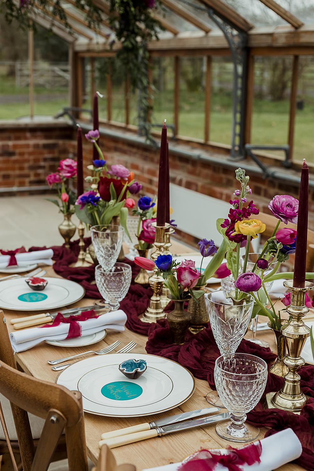 Somersbury Barn Wedding Thorn and Found Flowers Candles Table Decor Green Red Purple Blue Gold