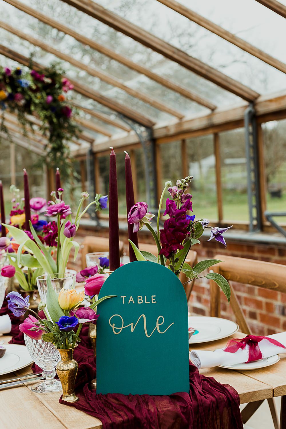 Somersbury Barn Wedding Thorn and Found Flowers Candles Table Decor Green Red Purple Blue Gold