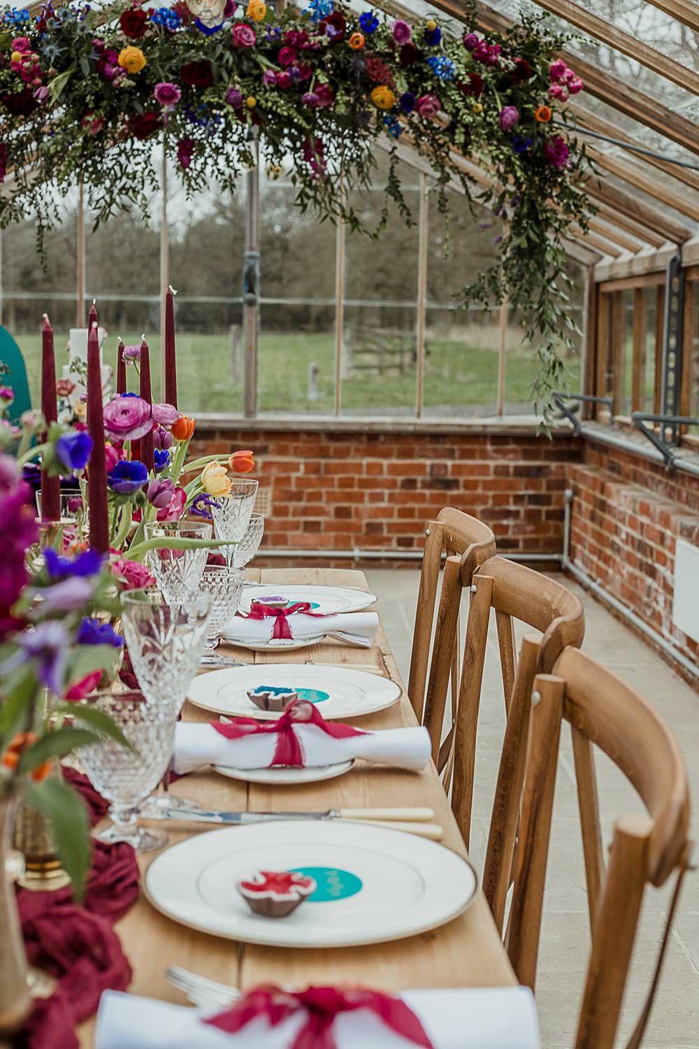 Somersbury Barn Wedding Thorn and Found Flowers Candles Table Decor Green Red Purple Blue Gold