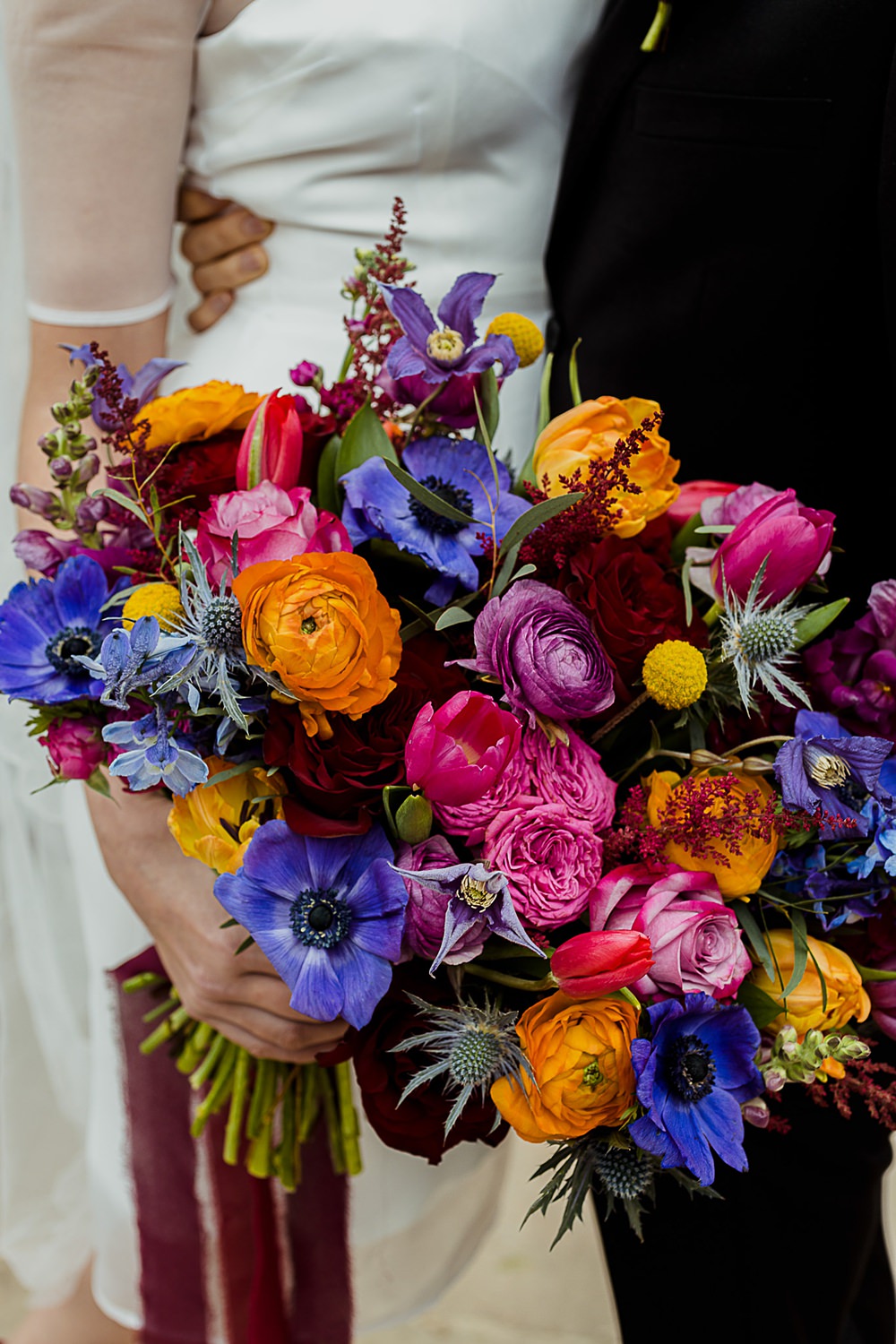 Somersbury Barn Wedding Thorn and Found Colourful Spring Bouquet Flowers Bride Bridal Orange Purple Blue Pink