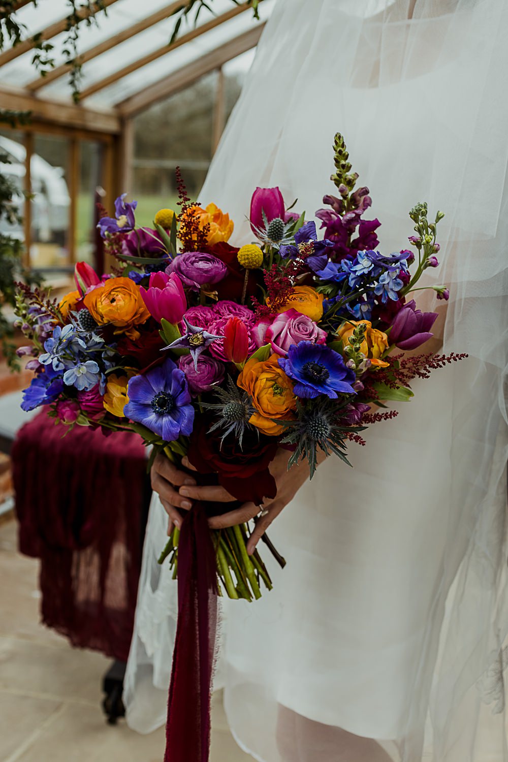 Somersbury Barn Wedding Thorn and Found Colourful Spring Bouquet Flowers Bride Bridal Orange Purple Blue Pink
