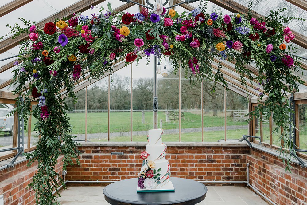 Somersbury Barn Wedding Tyler Rook Photography Flower Arch Colourful Cake Table