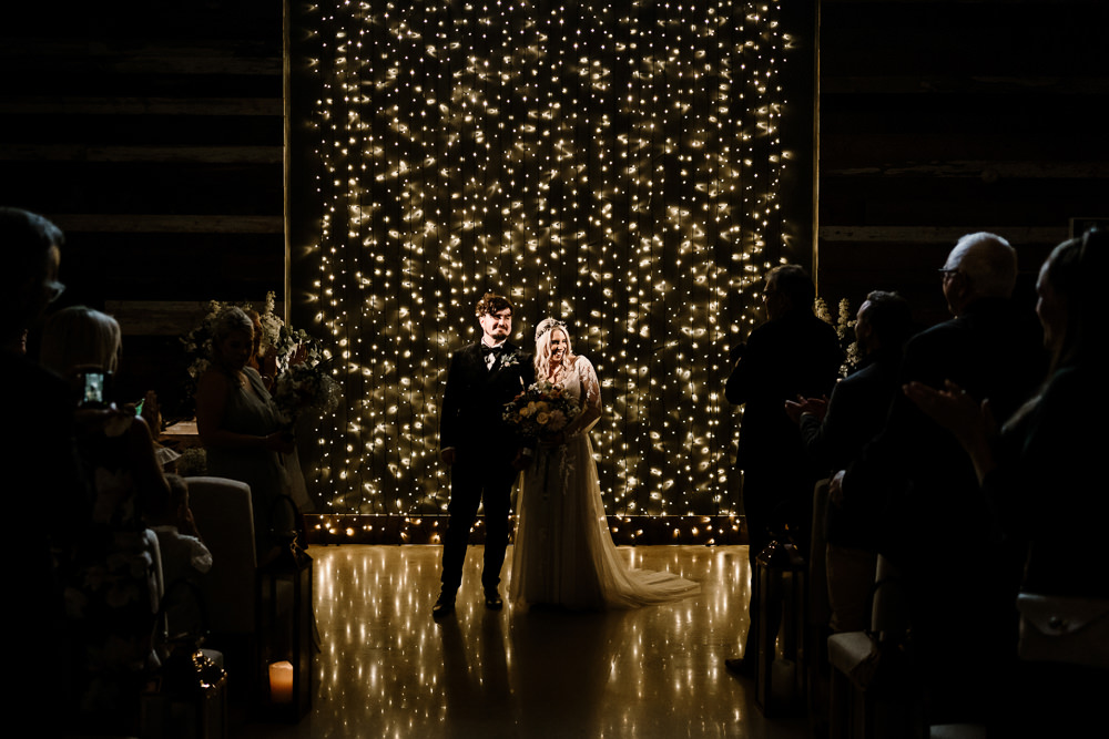 Ceremony Aisle Candles Fairy Light Wall Stylish Yorkshire Barn Wedding Hayley Baxter Photography
