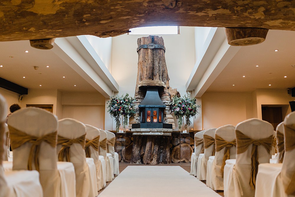 Log Burner Fireplace Flowers Ceremony Chair Bows Oxwich Bay Hotel Wedding Michelle Huggleston Photography