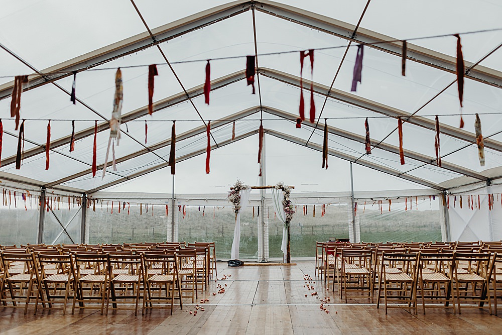 Clear Span Marquee Ceremony Bunting Arch Flowers Harvest Moon Weddings Lauren Stirling Photography