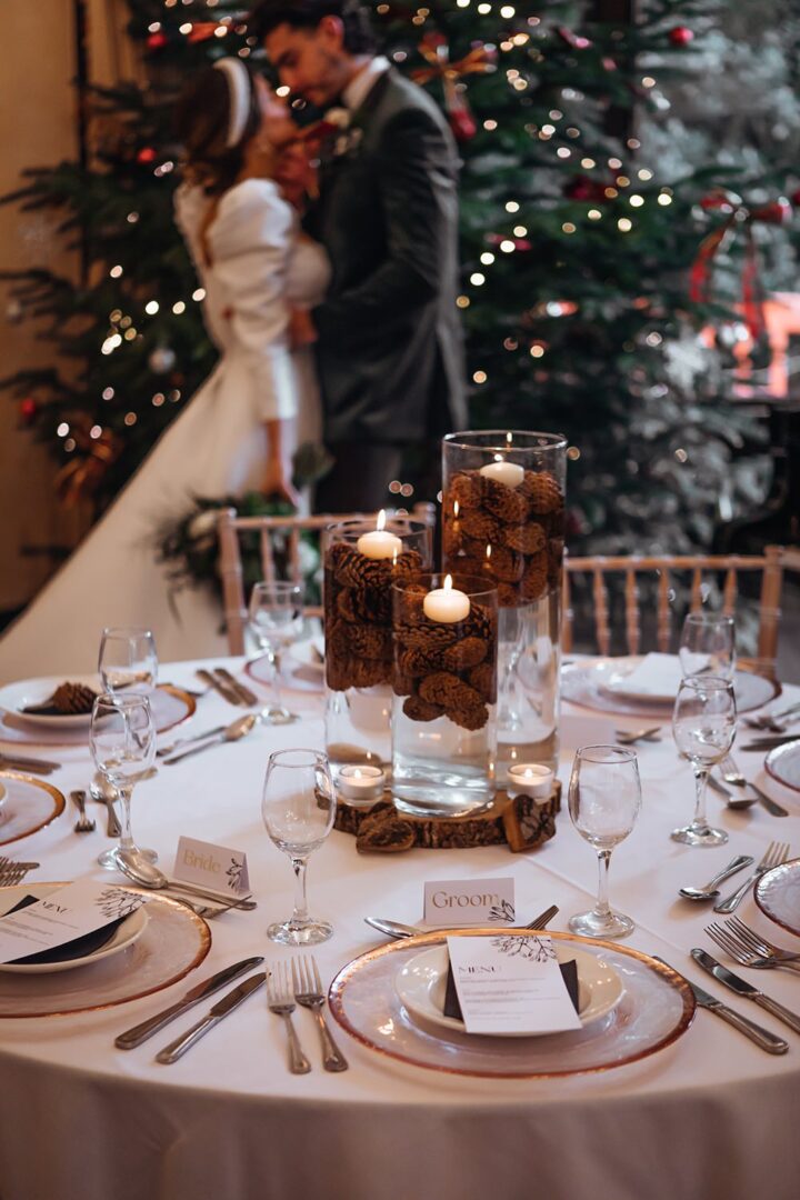 Winter Wedding Centrepiece Table Floating Candles Christmas Pine Cones Naomi Mills Photography