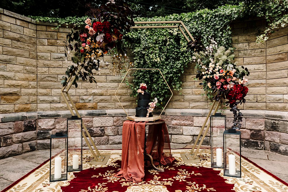 Cake Stand Backdrop Gold Hexagon Red Black Flowers Candles Dunwood Hall Estate Wedding Amy Faith Photography