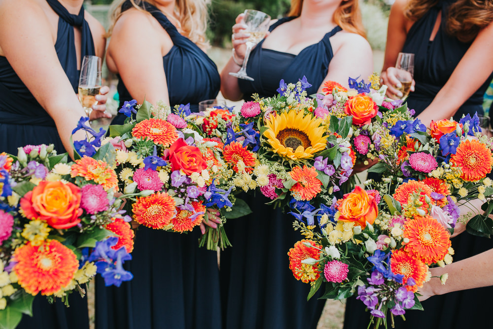Colourful Coral Bridesmaid Bouquets Charlotte Razzell Photography