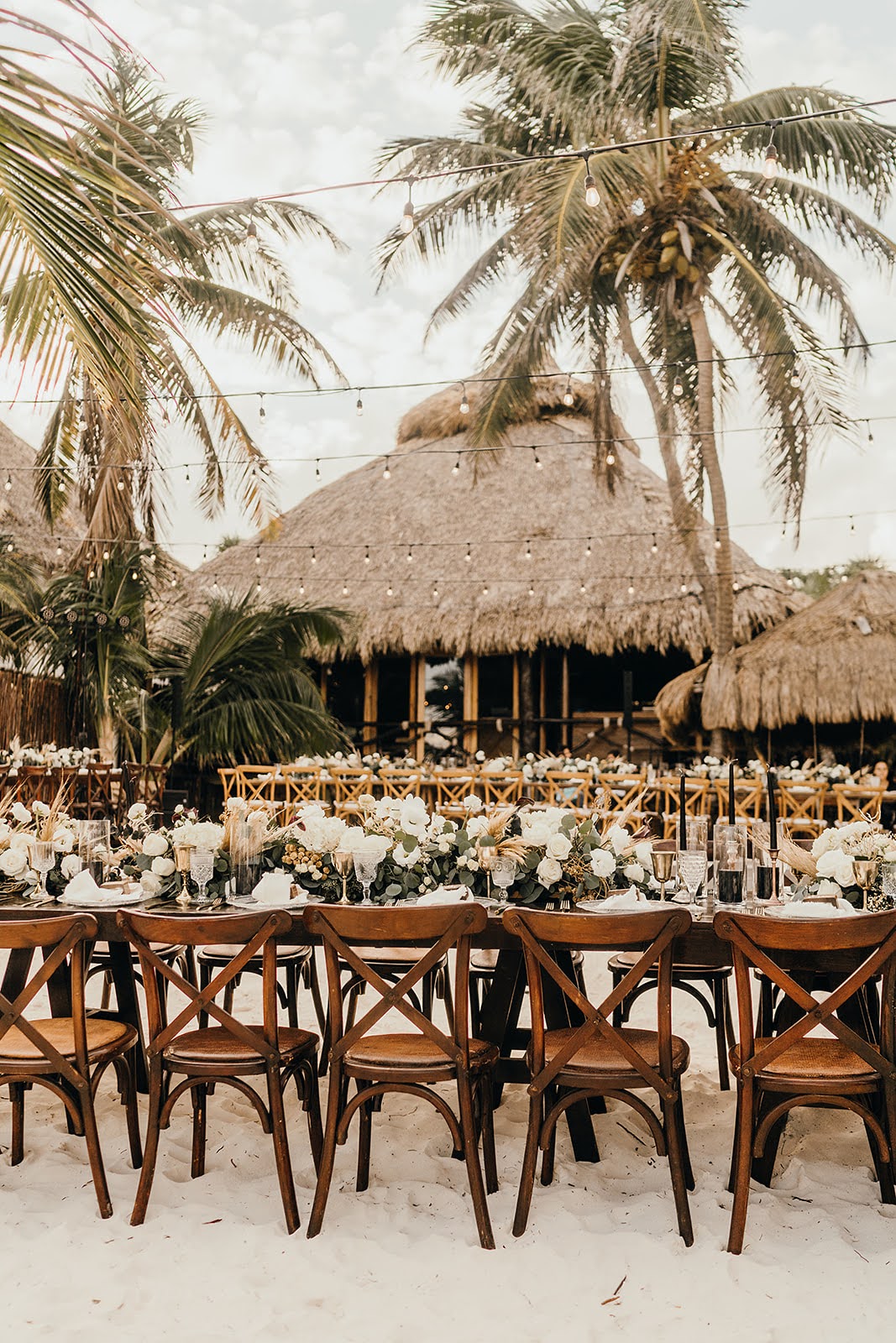 Akiin Tulum Wedding Beach Kape Photography Long Wooden Table White Flowers Pampas Grass Runner Black Candles Festoon Lights