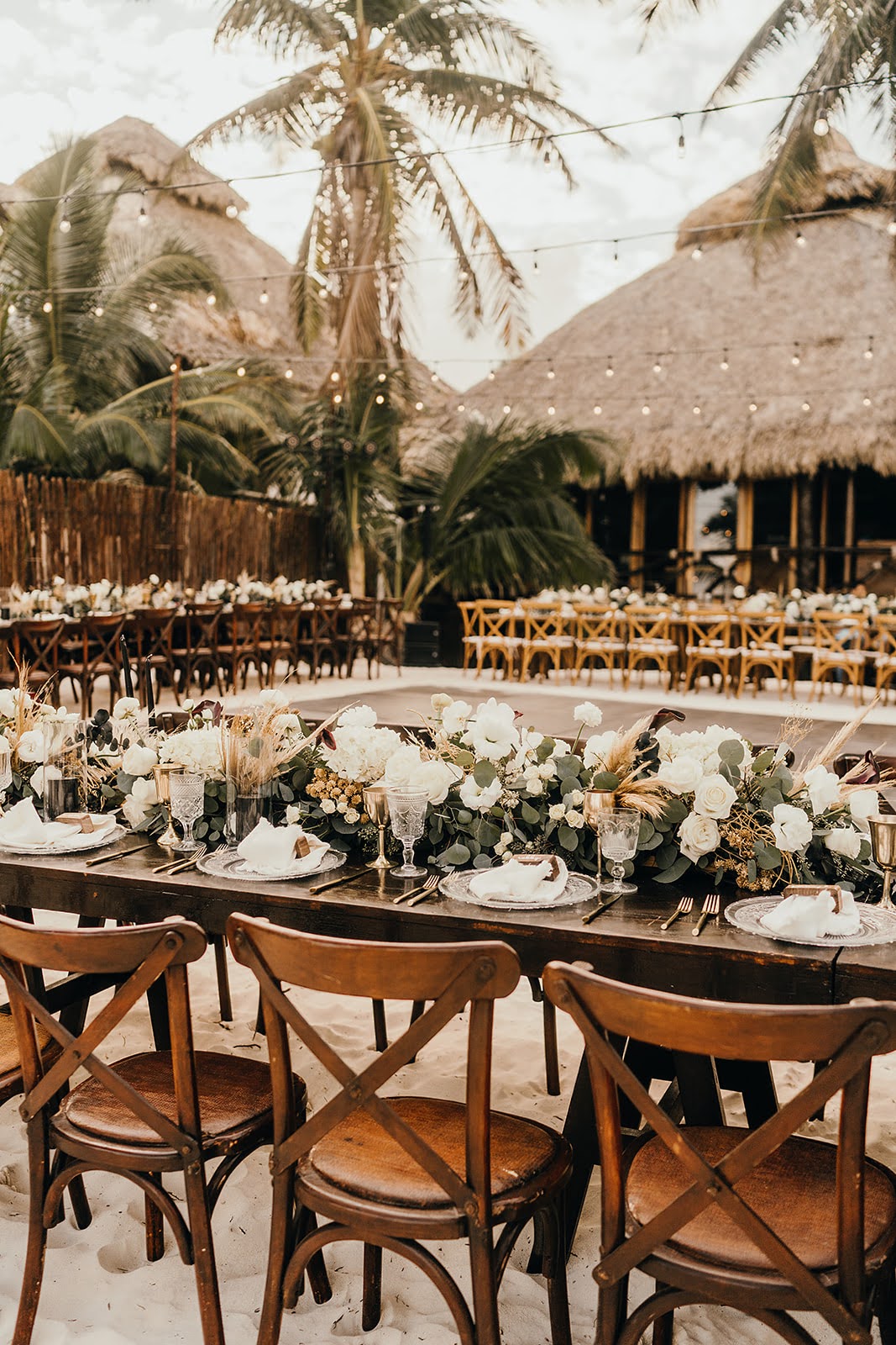 Akiin Tulum Wedding Beach Kape Photography Long Wooden Table White Flowers Pampas Grass Runner Black Candles Festoon Lights