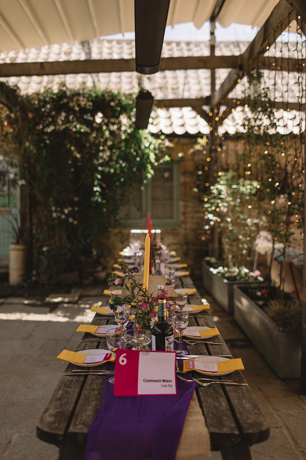 High Paradise Farm Wedding Louise Barry Photographer Yellow Napkins Tall Candles Wildflowers Rustic Wooden Table Decor