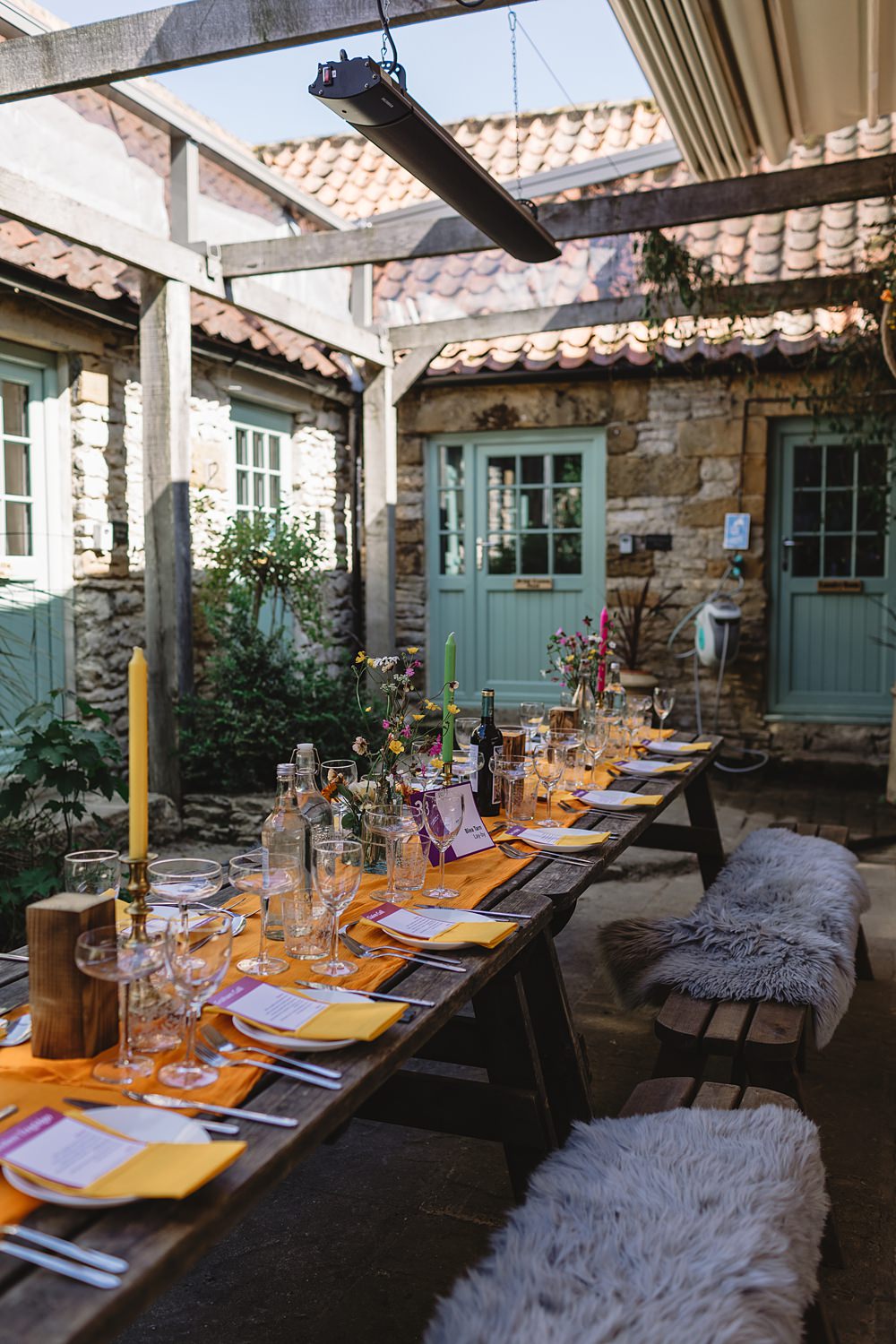 High Paradise Farm Wedding Louise Barry Photographer Yellow Napkins Tall Candles Wildflowers Rustic Wooden Table Decor