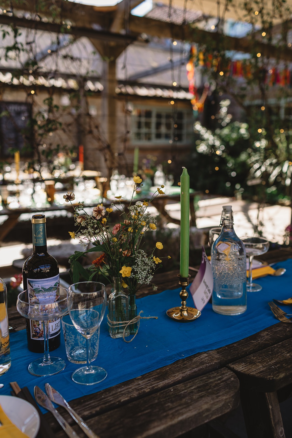 High Paradise Farm Wedding Louise Barry Photographer Wildflowers Centrepiece Blue Linen Table Tall Candles
