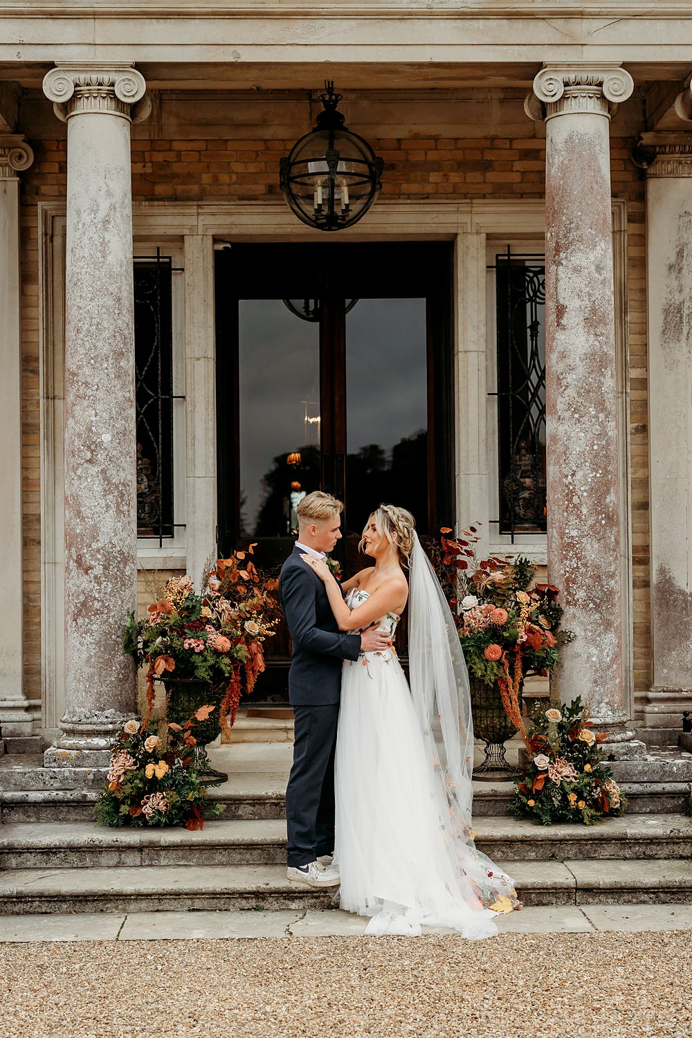 Rust Burnt Orange Autumn Wedding NK Photography Flower Pillars Doorway Arrangement