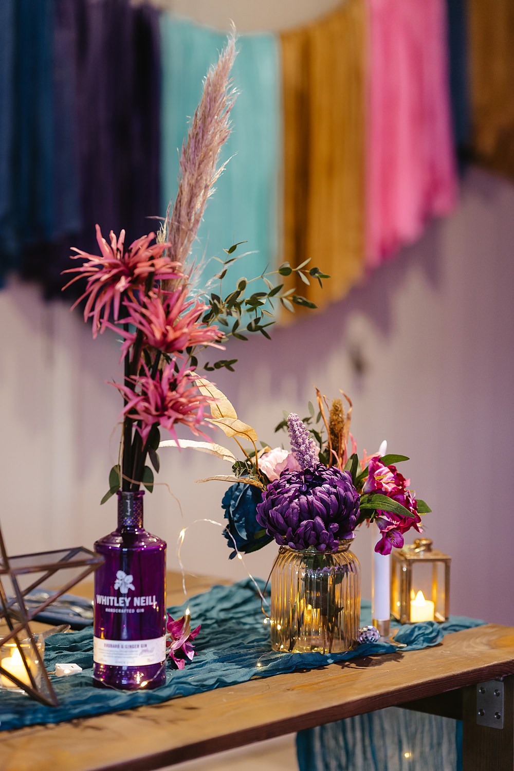 Stables at Ffolkes Wedding Cherrelle Blake Photography Table Decor Colourful Pink Blue Purple Flowers Candles Runner