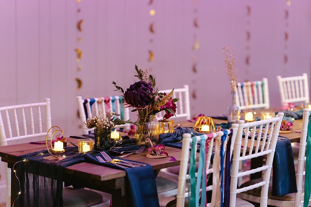 Stables at Ffolkes Wedding Cherrelle Blake Photography Table Decor Colourful Pink Blue Purple Flowers Candles Runner