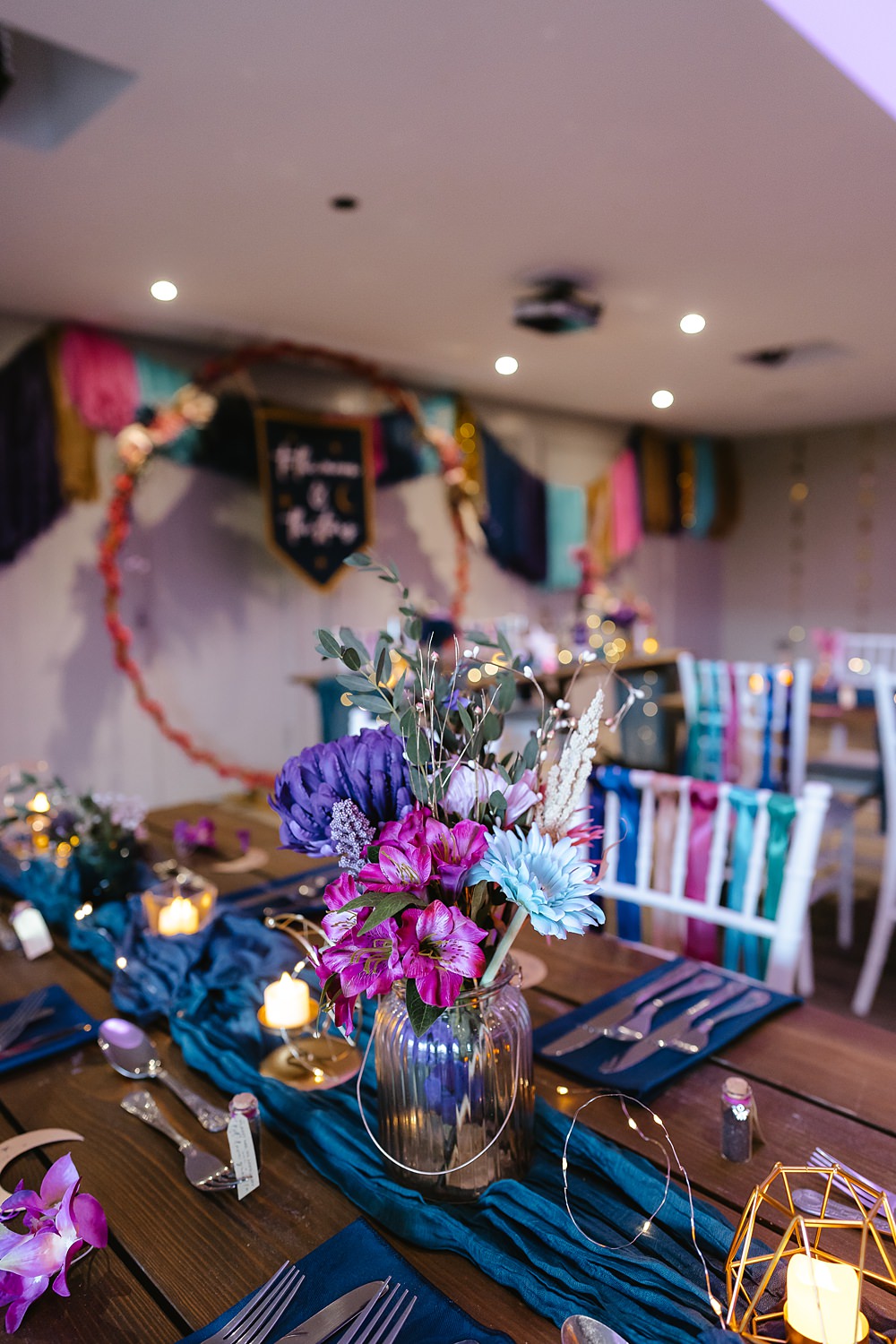 Stables at Ffolkes Wedding Cherrelle Blake Photography Table Decor Colourful Pink Blue Purple Flowers Candles Runner