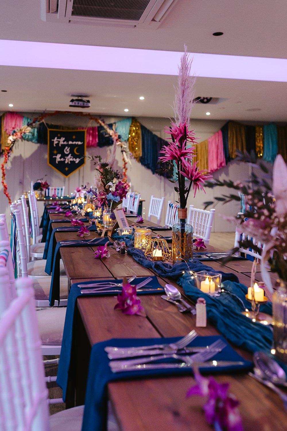 Stables at Ffolkes Wedding Cherrelle Blake Photography Table Decor Colourful Pink Blue Purple Flowers Candles Runner