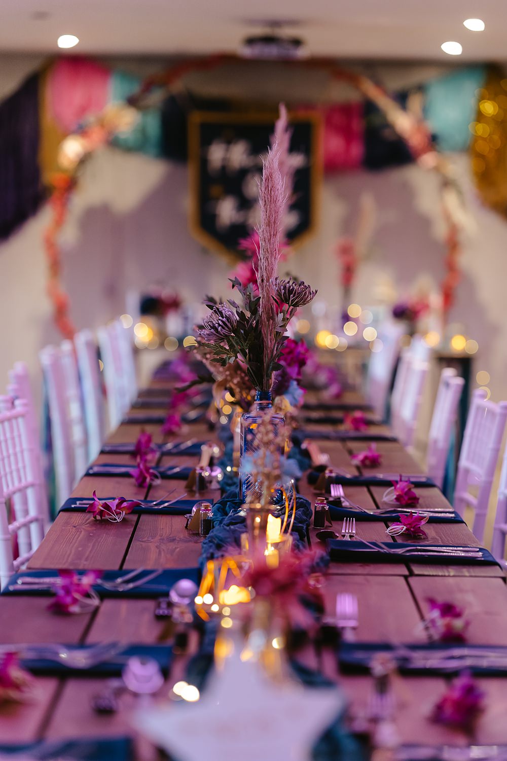 Stables at Ffolkes Wedding Cherrelle Blake Photography Table Decor Colourful Pink Blue Purple Flowers Candles Runner
