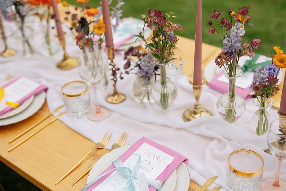Weddings At Woodfords Max Turner Weddings Wooden Table Colourful Wildflowers Flower Bottles Tall Candles Gold Decor