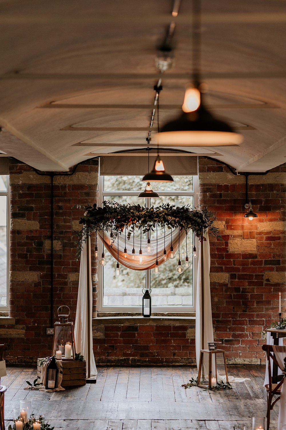 Cosy Romantic Wedding Hannah Shearman Photography Aisle Flowers Lanterns Candles Arch Backdrop