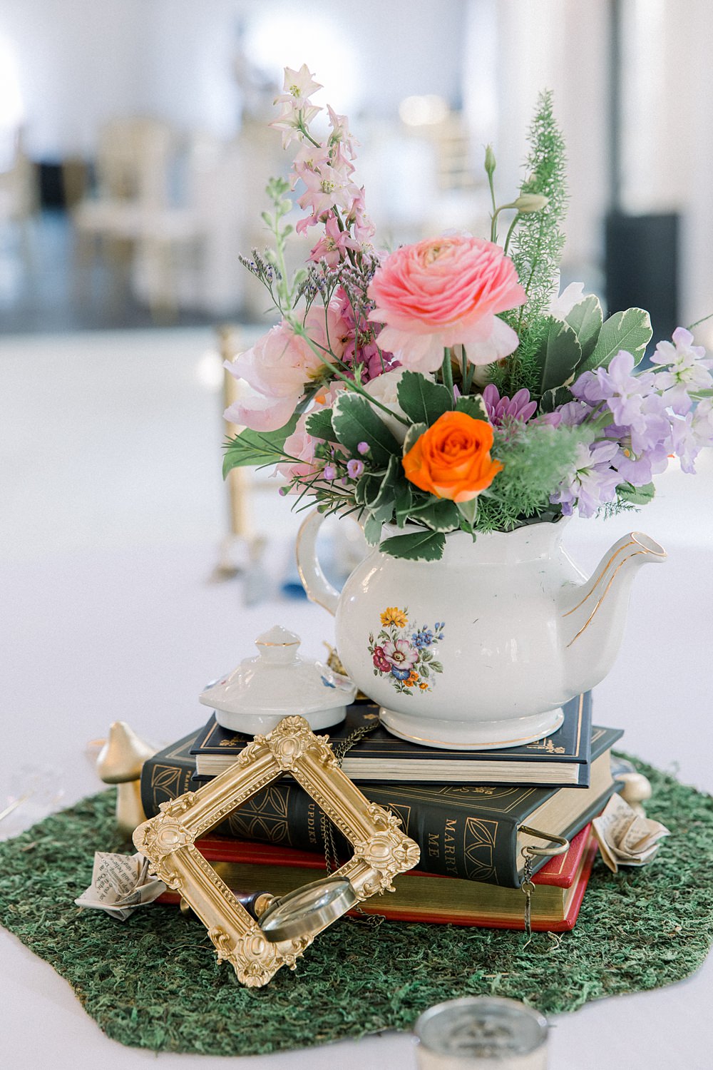 Mankin Mansion Wedding Willow Britt Studios Centrepiece Teapot Books Whimsical Decor Flowers