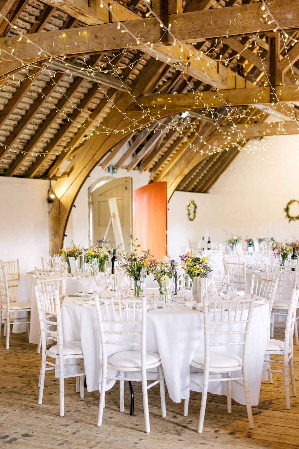 South Stoke Barn Wedding Gemma Vaughan Photography Barn Fairy Lights Circle Tables Flowers Centrepiece