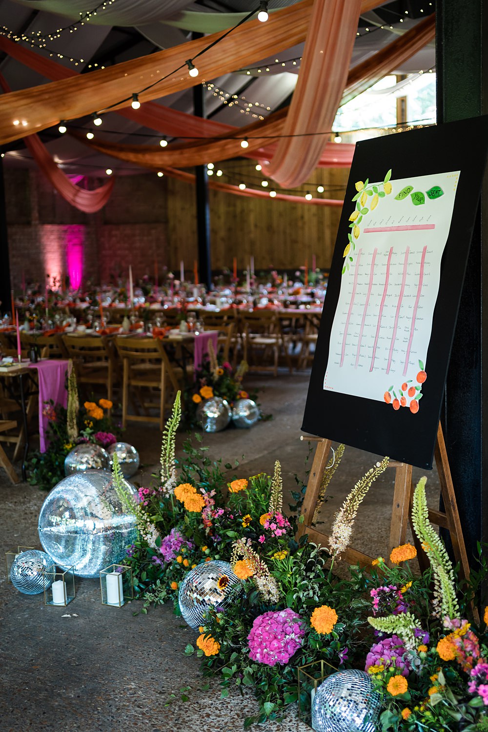 Pink Orange Disco Wedding Lisa and Neil Wedding Photography Table Plan Flowers Disco Balls